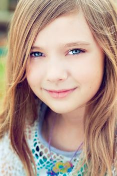 Portrait of a blode girl outdoors in the park 