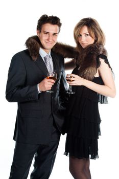 Portrait of a beautiful young couple with glasses of wine and a gift box with a red bow