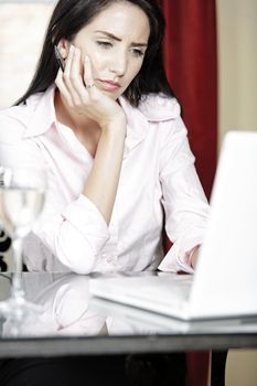 Attractive woman working on her laptop catching up after a long day.