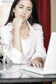 Attractive woman working on her laptop catching up after a long day.