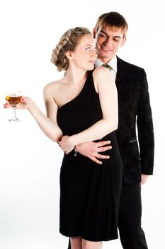 Portrait of a beautiful young couple with glasses of wine and a gift box with a red bow