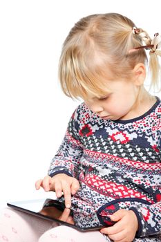 Portrait of 4 years girl using a touch pad