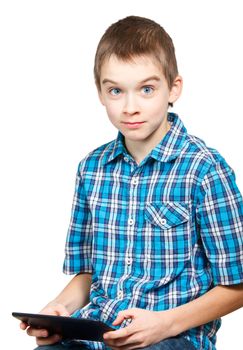Portrait of 10 years boy wearing blue shirt holding a touch pad