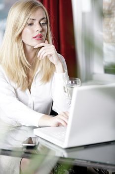 Attractive woman working on her laptop catching up after a long day.