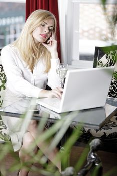 Attractive woman working on her laptop catching up after a long day.