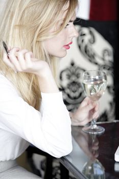 Woman in wine bar reading and expressing concern.