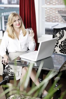 Attractive woman working on her laptop catching up after a long day.
