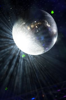 Glitter ball on dance floor with laser lights around
