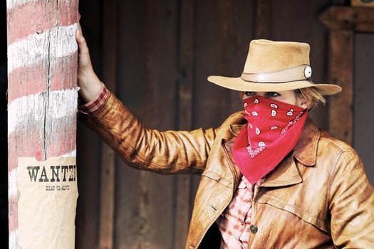 Portrait of bad wanted cowgirl. Western movie style 