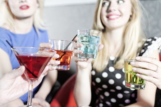 Attractive group of friends laughing and having fun in a nightclub