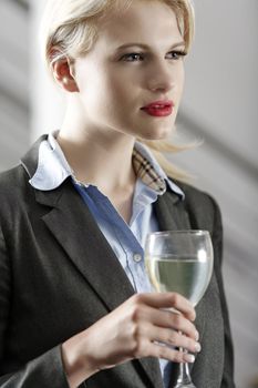 Young woman enjoying a glass of wine after work.
