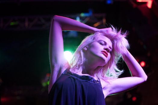 Attractive young woman dancing in a nightclub