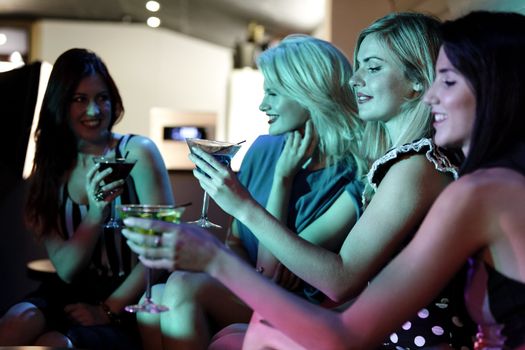 Attractive group of friends laughing and having fun in a nightclub