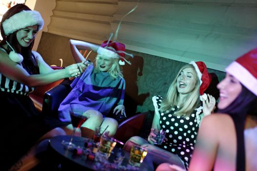 Attractive group of friends laughing and having fun at a Christmas party