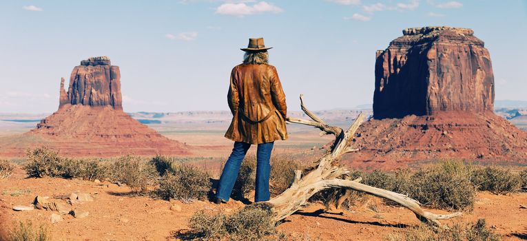 panoramic view of cowgirl at Monument Valley, Utah, USA