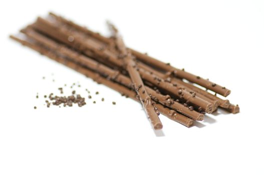Chocolate sticks with chocolate granules isolated on white background