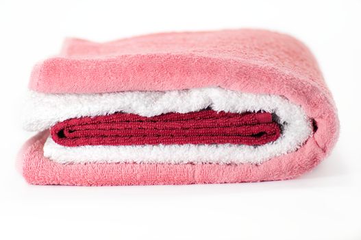 White, red and pink Terry towels isolated on white background