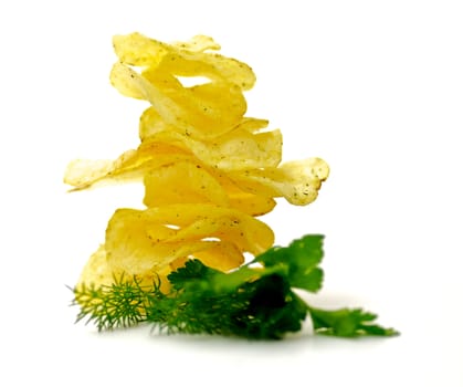 Potato Chips pyramid with dill and parsley isolated on white background