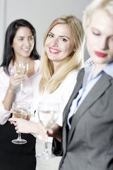 Beautiful young women enjoying a glass of wine after work at a bar.