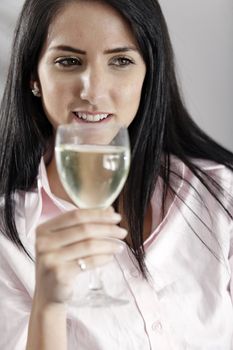 Young woman enjoying a glass of wine after work.