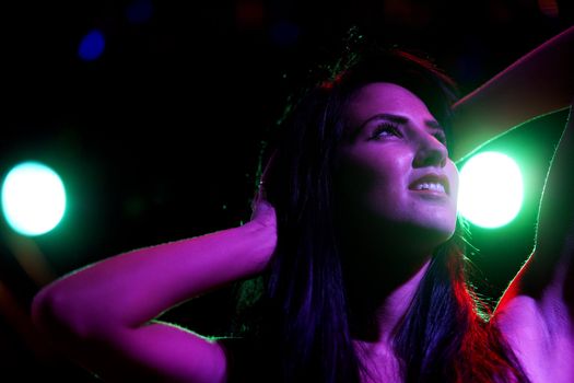 Attractive young woman dancing in a nightclub