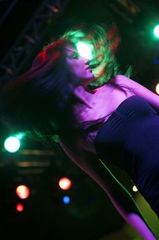 Attractive young woman dancing in a nightclub