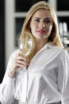 Young woman enjoying a glass of wine after work.