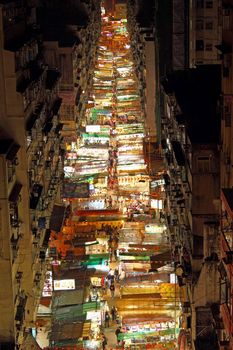 HONG KONG - 9 FEB, The busy Temple Street with many booths setting up to sell local products in Hong Kong at 9 February, 2011. It shows the typical Hong Kong culture from its crowdedness.