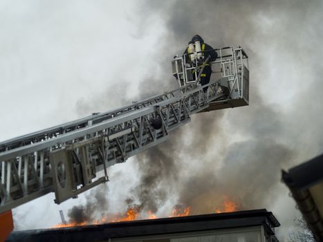 Fireman working on top of a ladder