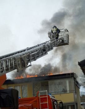 Fireman working on top of a ladder