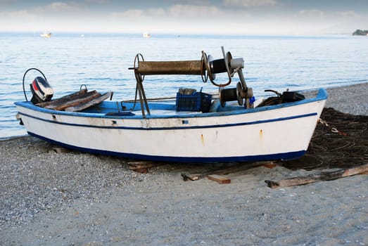 twilight with old fishing boat on beach