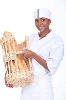 Bakery worker holding basket of bread