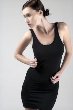 Woman wearing a little black dress on an isolated bakground
