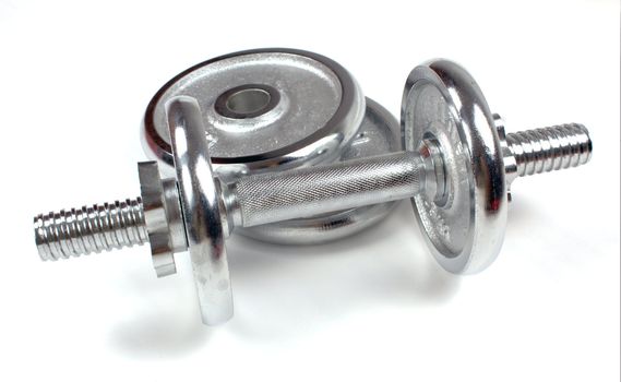 A metal dumbbell isolated on a white background, with shadow