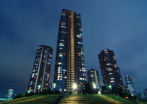 skyscraper buildings with night illumination inside modern Tokyo, Japan
