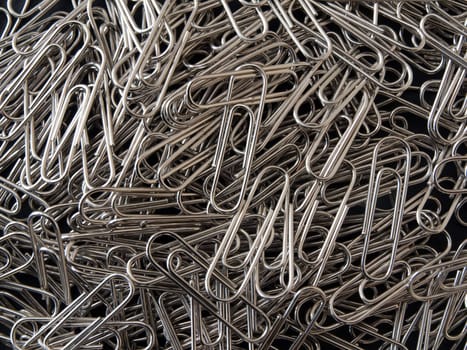 Close-up of lots of  silver paper clips .