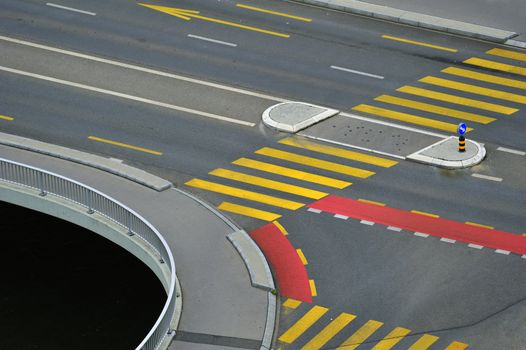 Abstract of a road junction with road markings making an abstract pattern. Suitable for background. Space for text bottom left in the black area.