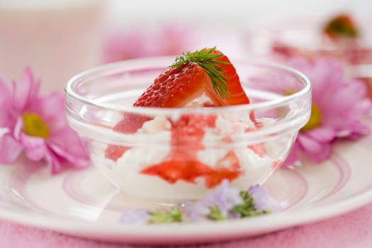 Delicious dessert with fresh ricotta and strawberries (shallow dof on herbs on top of strawberries)