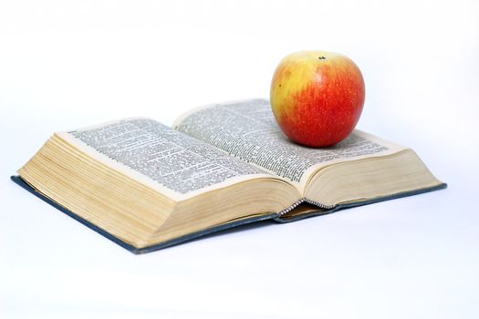 Apple and book on white background