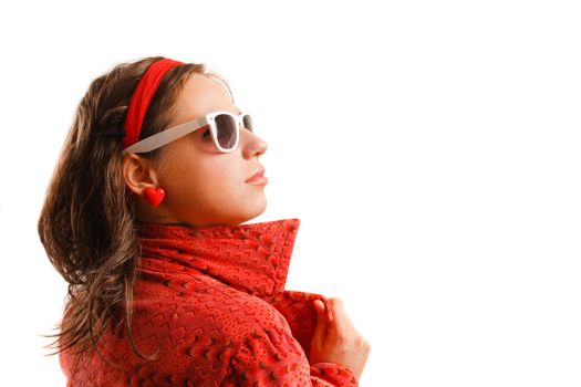 Modern looking young woman wearing a red jacket and sunglasses