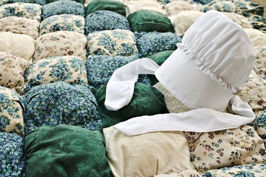 Amish bonnet on a biscuit quilt