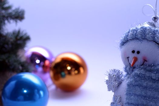 Christmas card with a snowman and christmas-tree decorations