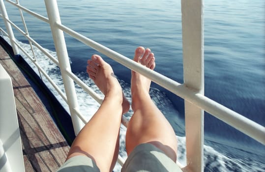 Woman legs on sea water background