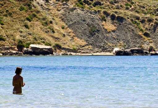 Woman in bikini at the beach in spring in Malta