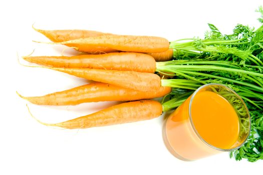 Fresh and ripe bunch of orange carrots with juice glass isolated on white background