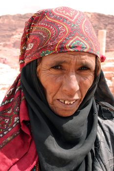 A bedouin elderly woman looks into the camera in Petra, Jordan