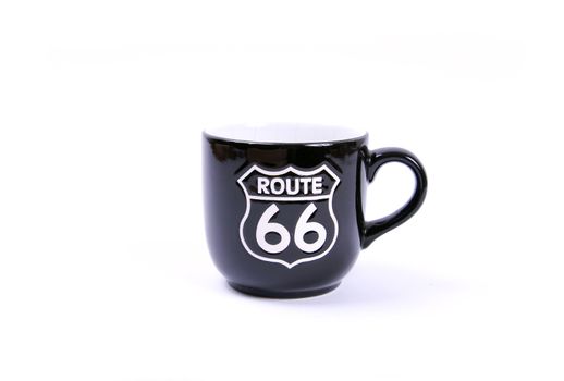 Route 66 sign on a single black mug. Isolated on white.