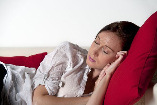 Woman asleep on sofa at home