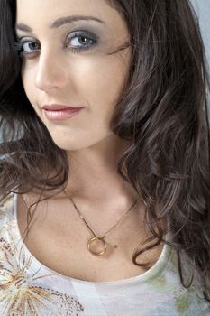 Portrait of a young attractive woman with curly dark hair