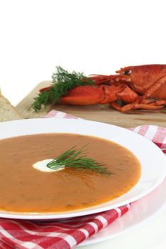 a bowl of lobster soup with dill and lemon